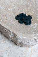 Another close-up of the buttons on the marbled beige stone, from a different angle.