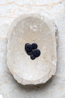 Close-up of the same buttons on the edge of a marbled beige stone.