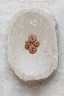Another close-up of the buttons on the marbled beige stone, from a different angle.