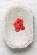 Close-up of the same buttons on the edge of a marbled beige stone.