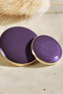Extreme macro close-up of the buttons, with a blurred background evoking the floral styling of the scene.