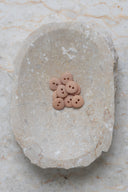 Close-up of the same buttons on the edge of a marbled beige stone.