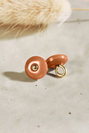 Domed round button with a central gold stud, caramel-brown pecan pie colourway, shown from the front and in profile revealing the gold-tone metal shank, on a light background.
