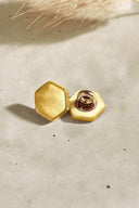 Close-up of the buttons shown from the back, revealing the gold metal shank fastening.