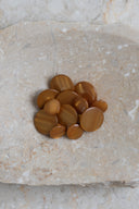 Close-up of the same buttons on the edge of a marbled beige stone.