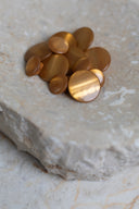 Top-down view of the buttons, stacked at the centre of a marbled beige stone.