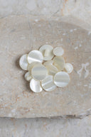 Close-up of the same buttons on the edge of a marbled beige stone.