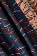 Close-up of the folds of the Fuji fabric, juxtaposing the dark Night colorway and the powder pink Blush colorway.