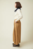 Patron Jupe Culotte – vue de profil gauche, jupe culotte camel, pull crème, foulard marine – Atelier Brunette