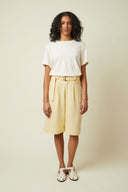 Bermuda shorts pattern – portrait front view, colourway pale yellow, white t-shirt and belt – Atelier Brunette