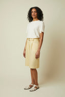 Bermuda shorts pattern – half-body front view, colourway pale yellow, white sandals – Atelier Brunette