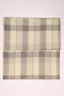 Le Carreau 006 ecru fabric with tartan-style mottled taupe checks, folded in half and viewed from above.