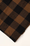 Le Carreau 009 caramel and black fabric with small buffalo-check style checks, rolled up showing the woven selvedge.